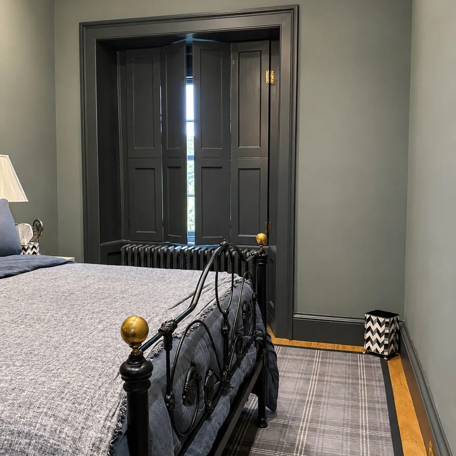 Bedroom with freshly painted dark woodwork and shutters, Edinburgh