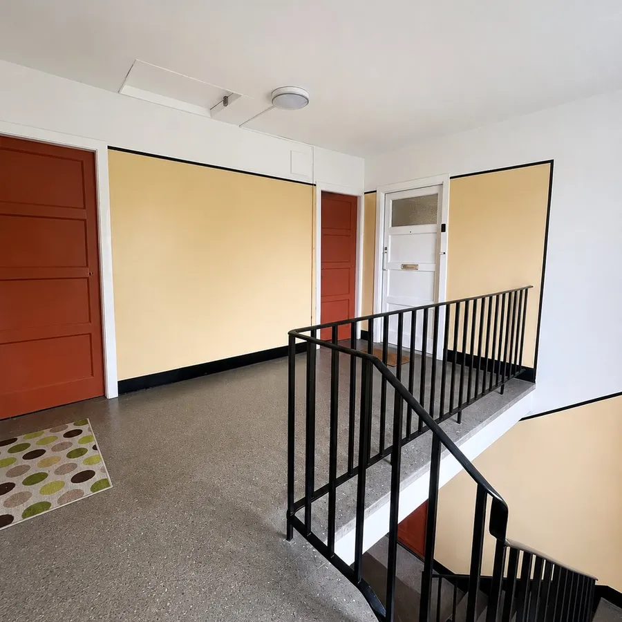 Repainted communal tenement stairwell with mustard and terracotta colour scheme, Edinburgh