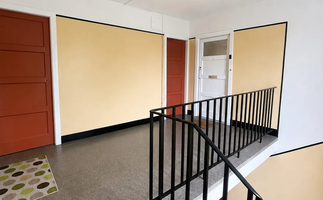 Repainted communal tenement stairwell with mustard and terracotta colour scheme, Edinburgh