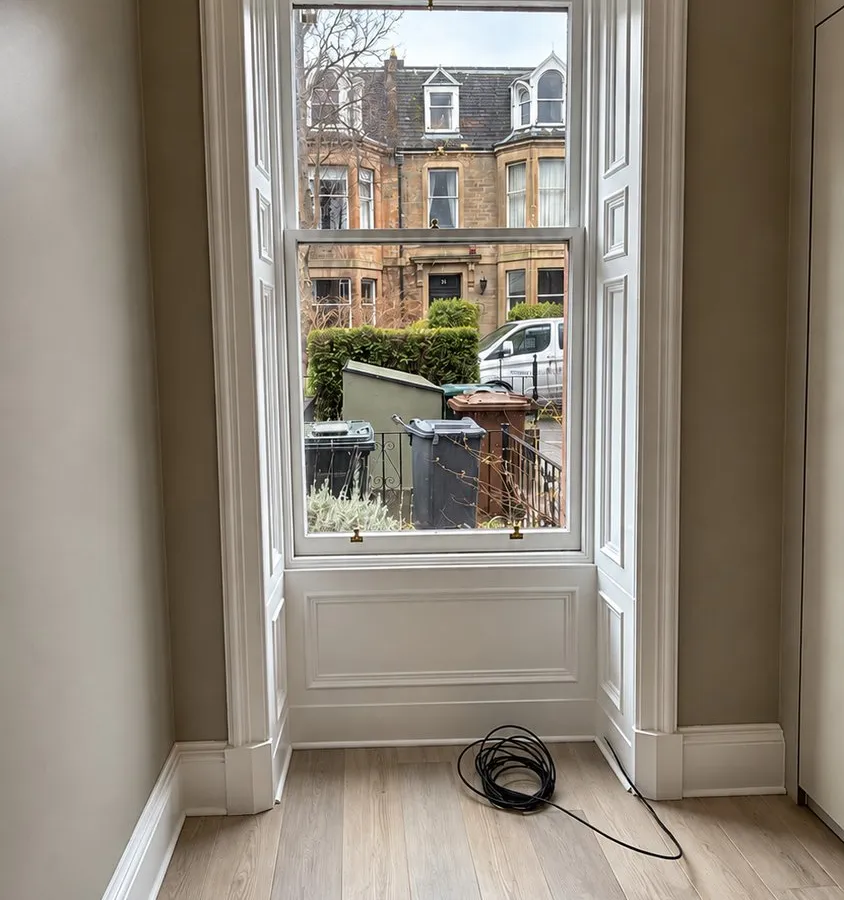 Repainted sash window with a view of sandstone terraces, Merchiston, Edinburgh