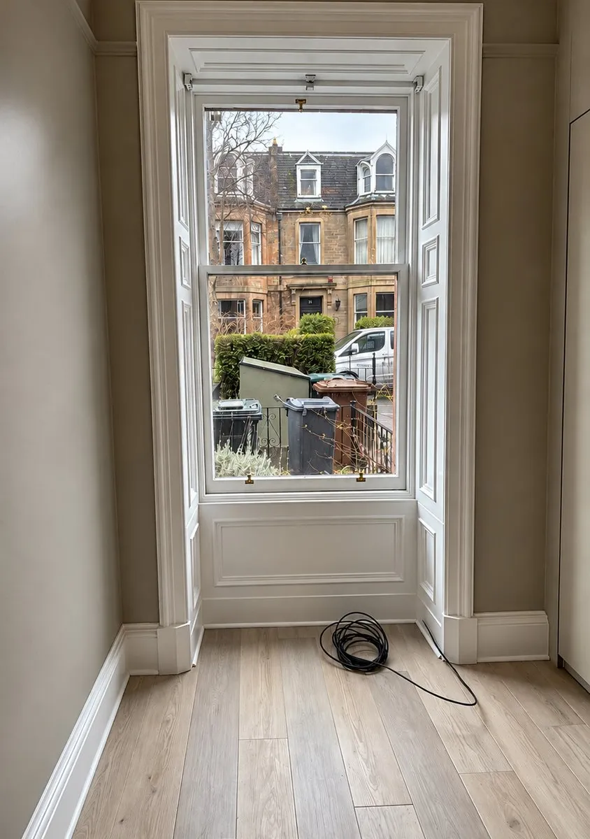 Repainted sash window with a view of sandstone terraces, Merchiston, Edinburgh