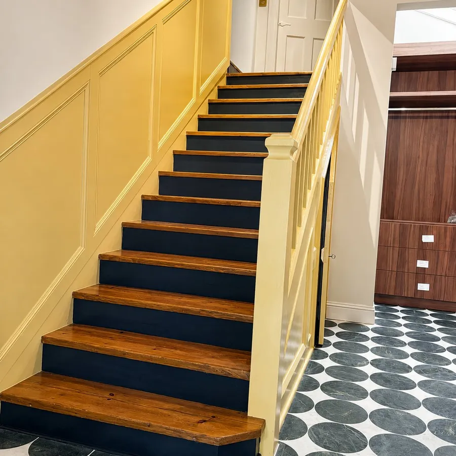 Repainted staircase with yellow panelling and navy treads, Inverleith, Edinburgh